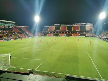 Group of people on soccer field at night