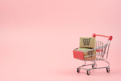 Close-up of electric lamp against pink background