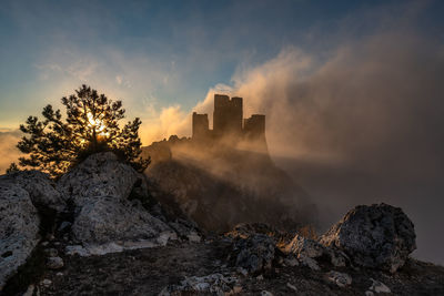 Low angle view of rock formations against sky during sunset