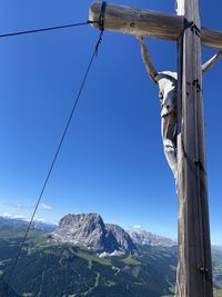 Low angle view of wooden post against clear sky