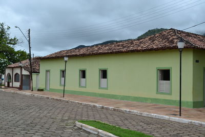 Houses against cloudy sky