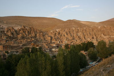 A frame from mountain top view of sugarloaf shaped houses in kandovan, iran.