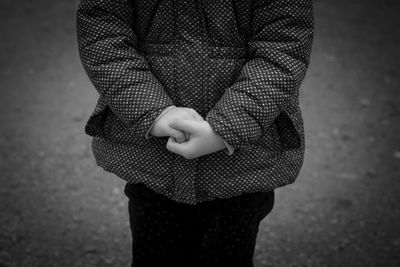 Midsection of kid wearing warm clothing during winter