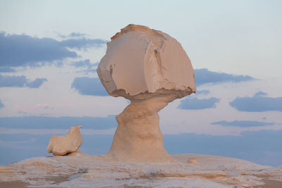 Rock formations on landscape against sky