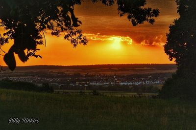 Scenic view of field against sky during sunset