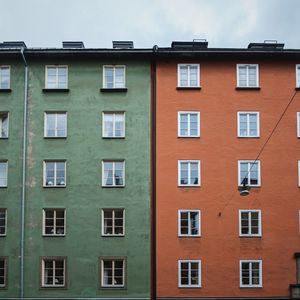 Low angle view of green and orange building