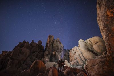 Low angle view of rock formation against clear sky at night