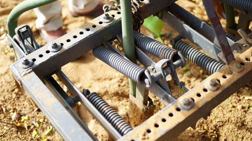 Spring mechanism on a old agricultural cultivator machine. spring shock absorbers cultivator.