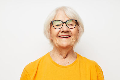 Portrait of senior woman against white background