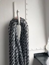 Close-up of rope hanging against wall at home