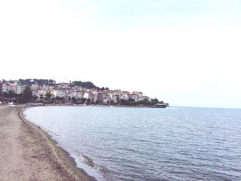 Scenic view of sea against sky in city