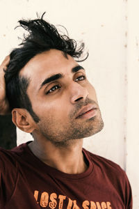 Close-up of thoughtful young man looking away