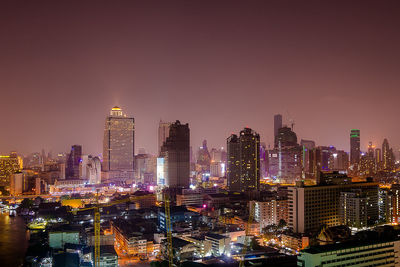 High angle view of illuminated cityscape against clear sky