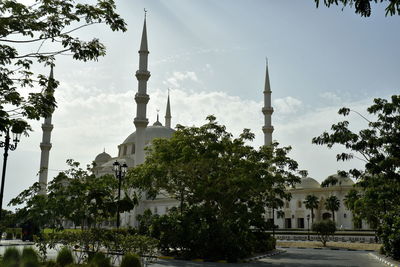 View of trees and buildings against sky