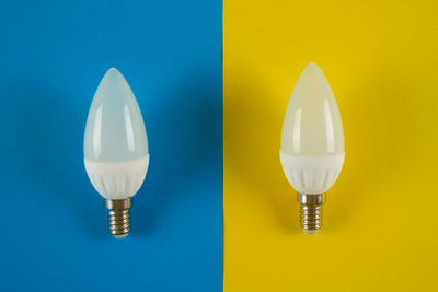 Close-up of light bulb against blue background