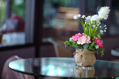 Close-up of flower vase on table at home