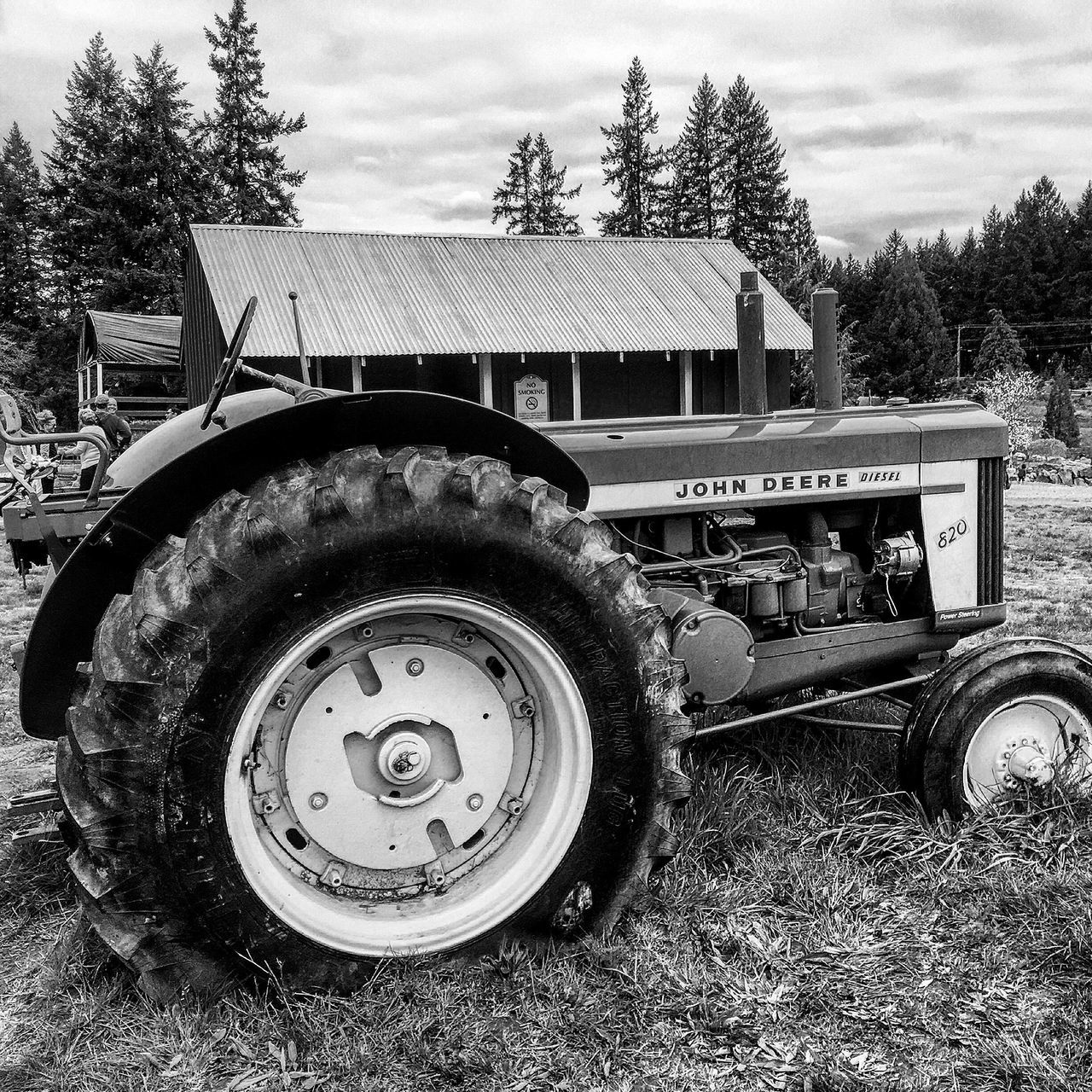 tree, architecture, building exterior, built structure, land vehicle, car, sky, text, retro styled, old-fashioned, communication, old, day, number, grass, western script, no people, outdoors, the past, metal