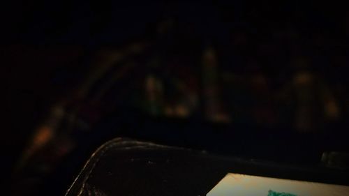 Close-up of illuminated lighting equipment in dark room