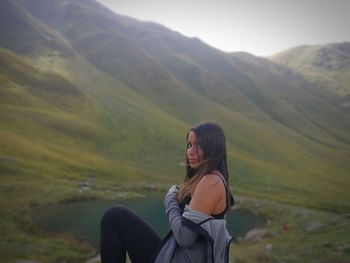 Side view of woman by scenic lake