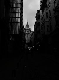 Street amidst buildings against sky in city