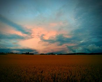 Scenic view of field against sky during sunset