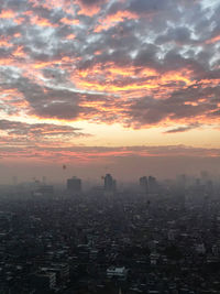 High angle view of buildings against sky during sunset