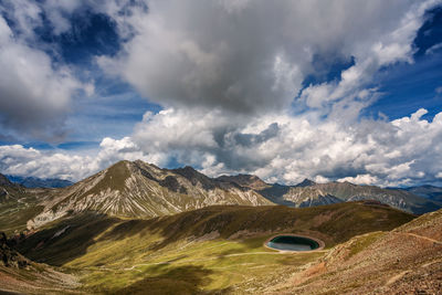 Scenic view of clouds over mountains against sky