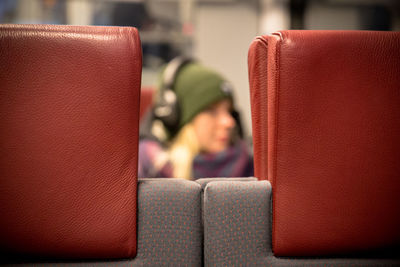 Midsection of person sitting on sofa