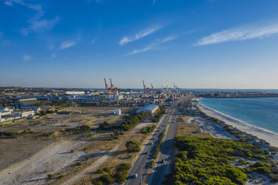 Panoramic view of harbor by sea against sky