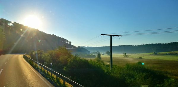 Road by mountain against sky