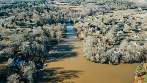 High angle view of river amidst trees in city