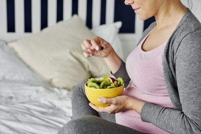 Midsection of woman holding ice cream