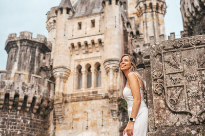 Woman standing at historical building