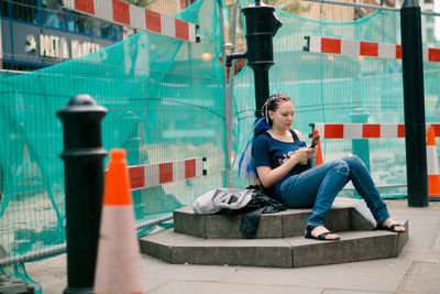 Side view of woman sitting on chair