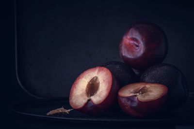 Close-up of apple on table against black background