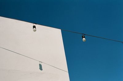 Low angle view of street light against building