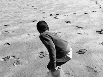 High angle view of boy standing at beach