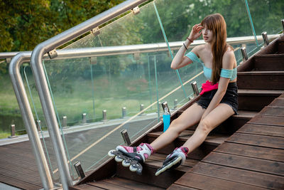 Rear view of woman sitting on staircase