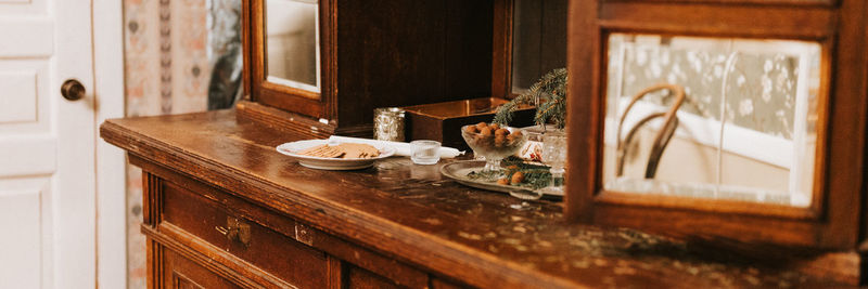 Vintage retro wooden granny sideboard or buffet with mirrors, decorated with christmas fir tree