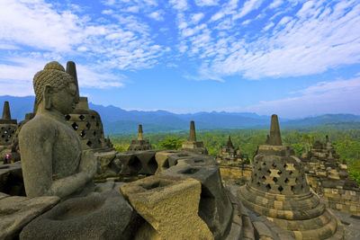 Ruins of temple against cloudy sky