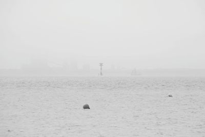 Scenic view of sea against sky during foggy weather