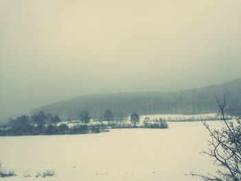 Scenic view of landscape against clear sky during winter