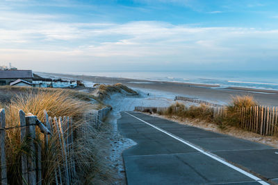 View of road by sea against sky