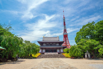 Tower of building against cloudy sky