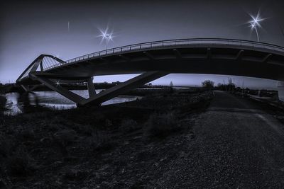 Sun shining through bridge