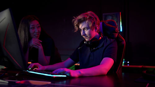 People playing video game in darkroom