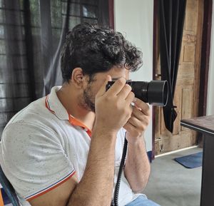 Portrait of young man photographing