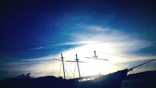 Low angle view of silhouette cranes against sky at night