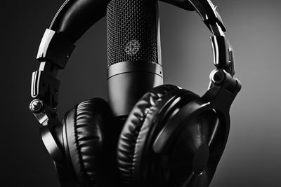 Studio microphone and headphones on the black background