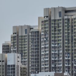 Buildings in city against clear sky